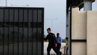 A Jordanian policeman opens the gate of Jordan's Jaber border crossing checkpoint near Syria's Nasib checkpoint, near Marfaq, Jordan, October 15, 2018. REUTERS/Muhammad Hamed