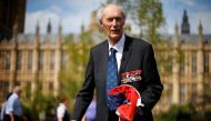 FILE PHOTO: World War Two Norwegian resistance fighter Joachim Roenneberg holds up a Union flag, which had been lowered from above the House of Lords, after it was presented to him by the Clerk of the House of Lords in Westminster, London, April 25, 2013.