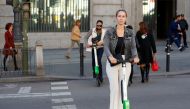 People ride dock-free electric scooters Lime-S by California-based bicycle and scooter sharing service Lime, over a crosswalk in Madrid, Spain, October 24, 2018. REUTERS/Paul Hanna