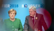 German Chancellor Angela Merkel (L) and Hesse's State Premier and Deputy Chairman of the Christian Democratic Union (CDU) Volker Bouffier address an election rally in Fulda, western Germany on October 25, 2018 ahead of the weekend's regional election. Ger