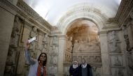 A visitor uses her mobile phone to take a selfie during the reopening of Syria's National Museum of Damascus, Syria October 28, 2018. REUTERS/Omar Sanadiki