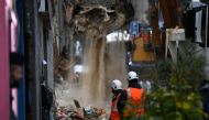 Workers renove the rubble at the site where two buildings collapsed, on November 6, 2018 in Marseille. French rescue workers were searching into the night Monday for possible victims under the wreckage of two dilapidated buildings that suddenly collapsed 