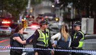 Police work at the crime scene following a stabbing incident in Melbourne on November 9, 2018.  / AFP / WILLIAM WEST