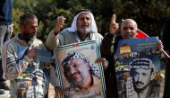 Demonstrators hold posters depicting late Palestinian leader Yasser Arafat during a rally marking the 14th anniversary of his death and against Jewish settlements, near Hebron, in the occupied West Bank November 11, 2018. Reuters/Mussa Qawasma