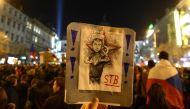 A protester holds up a sign depicting Czech Prime Minister Andrej Babis during a rally to protest against Babis, following a scandal of having managed subsidy fraud, on November 15, 2018 at the Wenceslas Square in Prague. AFP / Michal Cizek 