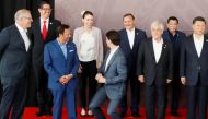 Canada's Prime Minister Justin Trudeau shares a joke about his height with New Zealand's Prime Minister Jacinda Ardern during a family photo at the APEC Summit in Port Moresby, Papua New Guinea November 18, 2018. REUTERS/David Gray 