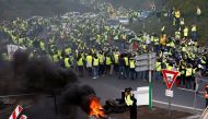 Protesters wearing yellow vests, a symbol of a French drivers' protest against higher fuel prices, attend a demonstration at the entrance of a shopping center in Nantes, France, November 17, 2018. REUTERS/Stephane Mahe