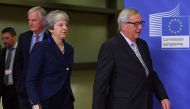 British Prime Minister Theresa May (C) is welcomed by European Commission President Jean-Claude Juncker (R) and Brexit Chief negotiator Michel Barnier (2L) at the European Commission in Brussels on November 24, 2018.   AFP / Emmanuel DUNAND
