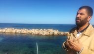 Coastguard official Ayman al-Dabbashi is seen on the seafront at the Libyan city of Sabratha, Libya November 21, 2018. Picture taken November 21, 2018. REUTERS/Aidan Lewis
