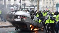 Demonstrators destroy a car during a protest of Yellow vests (Gilets jaunes) against rising oil prices and living costs on the Champs Elysees, in Paris, on December 1, 2018. T  AFP / Alain JOCARD
