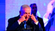 Israeli Prime Minister Benjamin Netanyahu gestures towards his eyes while delivering a speech before lighting candles during the start of Hanukkah, the Jewish festival of lights, in Ramat Gan in the suburbs of the Mediterranean coastal city of Tel Aviv on