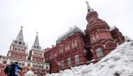 A man makes his way through a snow heap towards Red Square after a night of heavy snowfall in Moscow on December 6, 2018. AFP / Yuri Kadobnov 