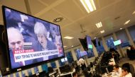 Britain's Prime Minister Theresa May is seen on a large television as traders work at CMC markets in London, Britain, December 11, 2018. REUTERS/Simon Dawson