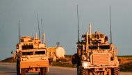 US Marine Corps tactical vehicles are seen driving along a road near the town of Tal Baydar in the countryside of Syria's northeastern Hasakeh province on December 21, 2018.  AFP / Delil SOULEIMAN