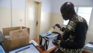 A worker of Congo's National Independent Electoral Commission (CENI), tests a voting machine ahead of the postponed presidential election, at the CENI offices in Kinshasa, Democratic Republic of Congo December 24, 2018. REUTERS/Kenny Katombe