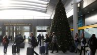 Passengers walk with suitcases in Gatwick Airport, in Crawley, Britain, December 22, 2018. REUTERS/Peter Nicholls