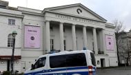 A police car stands in front of the theatre while police forces examine the crime scene at the back-side, where far-right Alternative for Germany (AfD) party member Frank Magnitz was attacked by unknown assailants, in Bremen, Germany January 8, 2019. REUT