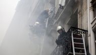 A person is evacuated by firefighters from an apartment after the explosion of a bakery on the corner of the streets Saint-Cecile and Rue de Trevise in central Paris on January 12, 2019.   AFP / Thomas SAMSON