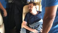 A picture handout by the Italian Interior Ministry clicked and released by the Polizia di Stato on January 13, 2019, shows former far-left Italian militant Cesare Battisti sitting aboard a plane chartered by the Italian government, prior to taking off fro
