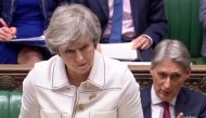A video grab from footage broadcast by the UK Parliament's Parliamentary Recording Unit (PRU) shows Britain's Chancellor of the Exchequer Philip Hammond (R) gesturing as Britain's Prime Minister Theresa May makes a statement to the House of Commons in Lon