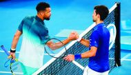 Serbia's Novak Djokovic (R) shakes hand with France's Jo-Wilfried Tsonga after their men's singles match on day four of the Australian Open tennis tournament in Melbourne early January 18, 2019. AFP / David Gray