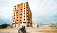 Palestinians ride a motorcycle past a newly-contsructed building funded by Iran to house Palestinian prisoners formerly held in Israeli jails, in Khan Yunis in the southern Gaza Strip on January 17, 2019.  AFP / Said Khatib