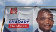 Men remove an electoral campaign banner of Emmanuel Ramazani Shadary, former Congolese interior minister and presidential candidate, in Kinshasa, Democratic Republic of Congo, January 2, 2019. Reuters/Baz Ratner