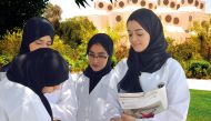 Public Health students discussing a point at Qatar University campus. RIGHT: A professor guiding a student doing a lab test.