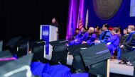 NU-Q students and dignitaries during a graduation ceremony.