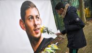 A young man brings flowers in front of the entrance of the FC Nantes football club training center La Joneliere in La Chapelle-sur-Erdre on January 23, 2019, two days after the plane of Argentinian forward vanished during a flight from Nantes in western F