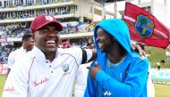 Darren Bravo (L) and Kemar Roach (R) of West Indies celebrate winning on day 3 of the 2nd Test between West Indies and England at Vivian Richards Cricket Stadium in North Sound, Antigua and Barbuda, on February 02, 2019. / AFP / Randy Brooks 