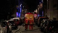Firefighters are seen near a building that caught fire in the 16th arrondissement in Paris, on February 5, 2019. AFP / Geoffroy VAN DER HASSELT