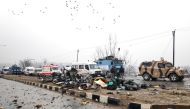 Indian soldiers examine the debris after an explosion in Lethpora in south Kashmir's Pulwama district February 14, 2019. (REUTERS/Younis Khaliq)
