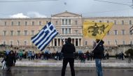 Protesters stand in front of the Greek Parliament in Athens on January 25, 2019. AFP / Louisa Gouliamaki