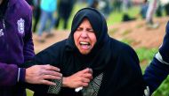 A Palestinian woman reacts from tear gas fired by Israeli troops during a protest at the Israel-Gaza border fence, east of Gaza City February 15, 2019. Reuters/Mohammed Salem
