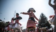 This photo taken on February 14, 2019 shows girls from the Long Horn Miao, a branch of the Miao ethnic minority group, taking part in the annual flower festival or 'Tiaohuajie' in the village of Longjia in China's Guizhou province.  / AFP / FRED DUFOUR 