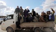 Members of Syrian Democratic Forces (SDF) gesture as they ride a truck in the village of Baghouz, Deir Al Zor province, Syria February 17, 2019. REUTERS/Rodi Said