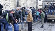 Syrians queue for gas canisters in the Salah al-Din district of the northern city of Aleppo on February 11, 2019. AFP / LOUAI BESHARA

