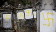 Graves that were desecrated with swastikas are seen at the Jewish cemetery in Quatzenheim, near Strasbourg, France, February 19, 2019. Reuters/Vincent Kessler