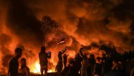 Palestinians burn torches and tires during the 