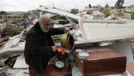 A Palestinian man, salvages some of his belongings from his house that was demolished by Israeli troops in the Arab east Jerusalem neighbourhood of Beit Hanina on February 20, 2019, on the grounds that it was built without a construction permit.  AFP / Ah