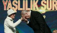 President of Turkey, Recep Tayyip Erdogan (R) kisses an elderly's hand during the 