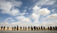 People walk during a march from the city of Aqaba south of the capital, demanding more employment opportunities, on the highway near Amman, Jordan, February 20, 2019. Reuters/Muhammad Hamed 