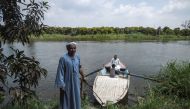 Workers in a mango farms ride a boat on a branch of the Nile after finishing their work in the Al Qata village, Giza Governorate, on August 27, 2018. AFP/Mohamed el-Shahed