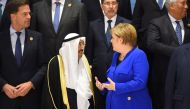 Germany's Chancellor Angela Merkel talks with Emir of Kuwait Sheikh Sabah al-Ahmad Al-Sabah during the first joint European Union and Arab League summit at the International Congress Centre in the Egyptian Red Sea resort of Sharm el-Sheikh, on February 24
