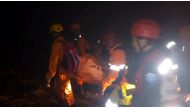 Rescue workers carry a body bag containing a victim following the collapse of an illegal gold mine at Bolaang Mongondow regency in North Sulawesi, Indonesia, February 26, 2019 in this photo taken by Antara Foto. Picture taken February 26, 2019. Antara Fot