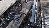 Firefighters and onlookers gather at the scene of a fiery train crash at the Egyptian capital Cairo's main railway station on February 27, 2019.  AFP / STRINGER