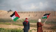 Palestinians hold Flags of Palestine during 