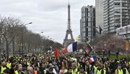 French yellow vests (Gilets jaunes) protesters walk near the Eiffel Tower during the 'Act XVI' demonstration (the 16th consecutive Saturday national protest) in Paris, France on March 2, 2019. Mustafa Yalç?n - Anadolu