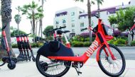 A jump electric bicycle and scooters available to rent by-the-mile through the Uber smartphone application are seen near a road in Santa Monica, California on Febuary 26, 2019 . AFP / Glenn Chapman
